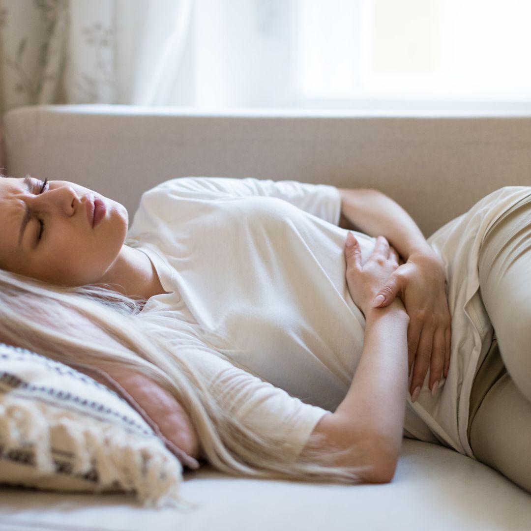 Woman holding her stomach in pain